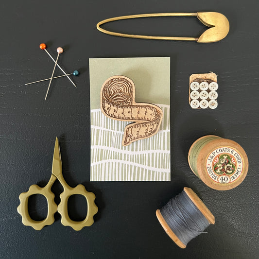 Tape measure etched wooden brooch