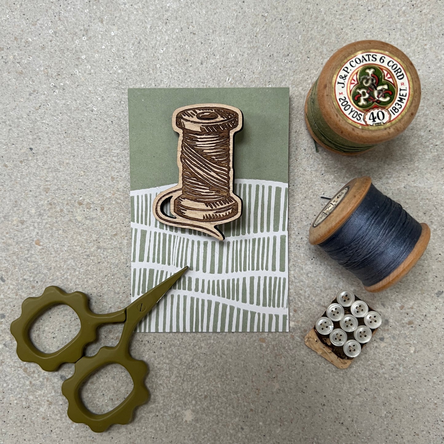 Cotton reel etched wooden brooch