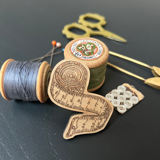 Tape measure etched wooden brooch