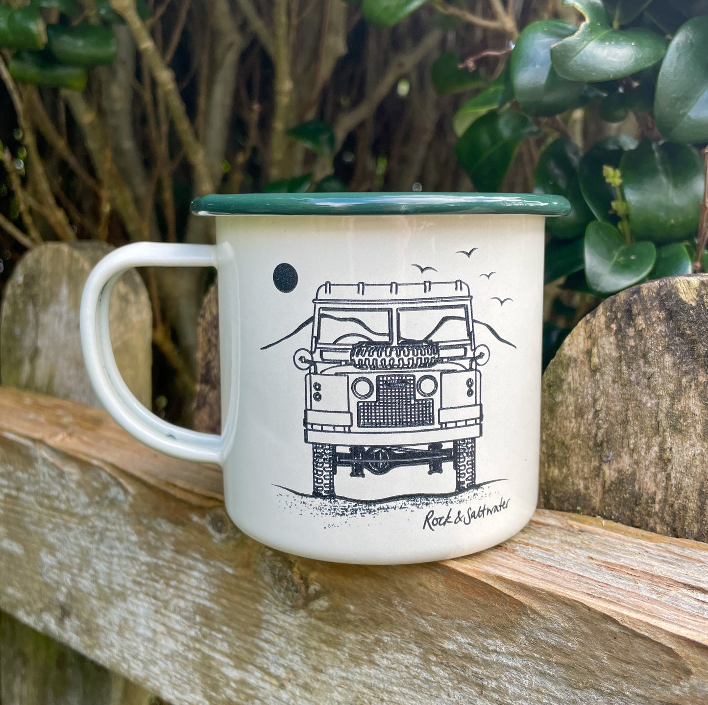 Land Rover front view with mountain enamel mug