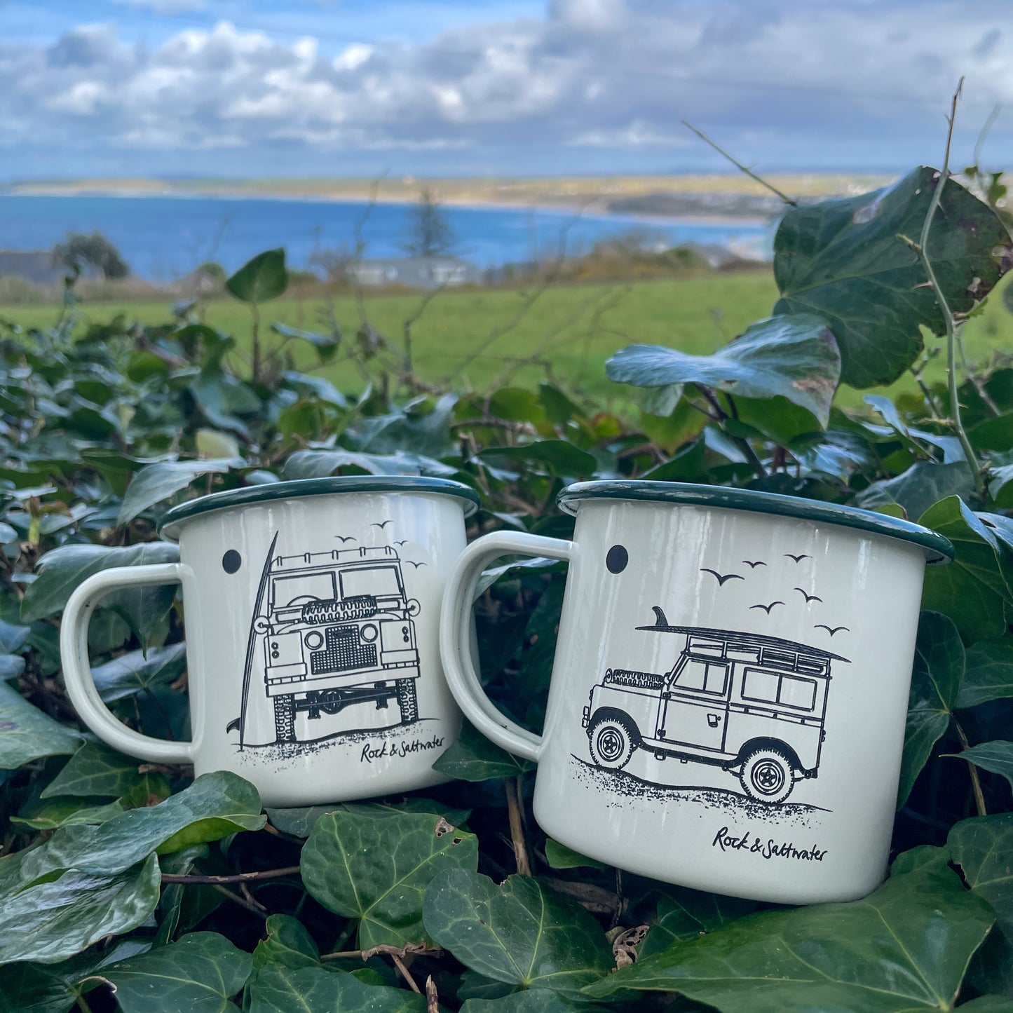 Land Rover side view with surfboard on beach enamel mug