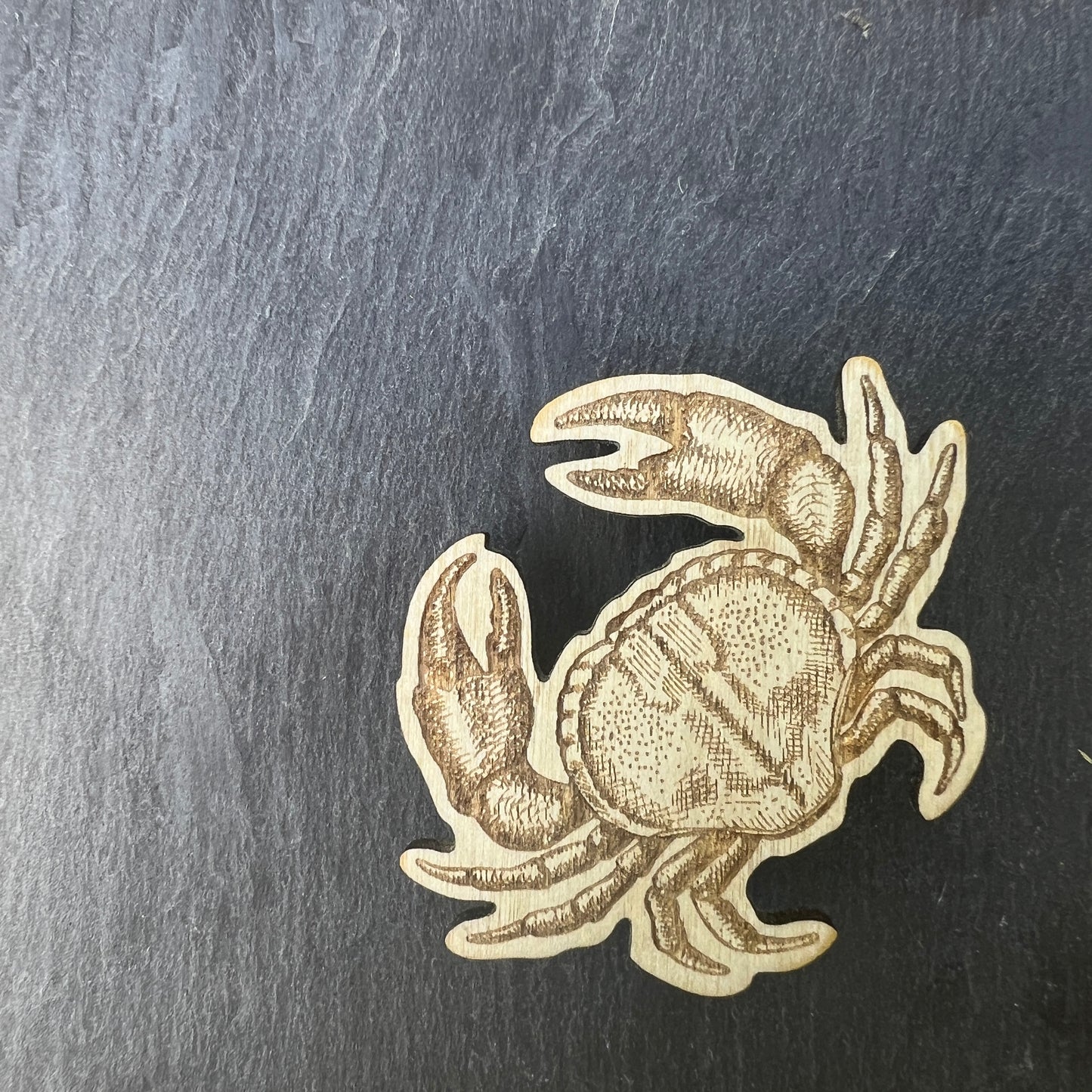 Crab etched wooden badge